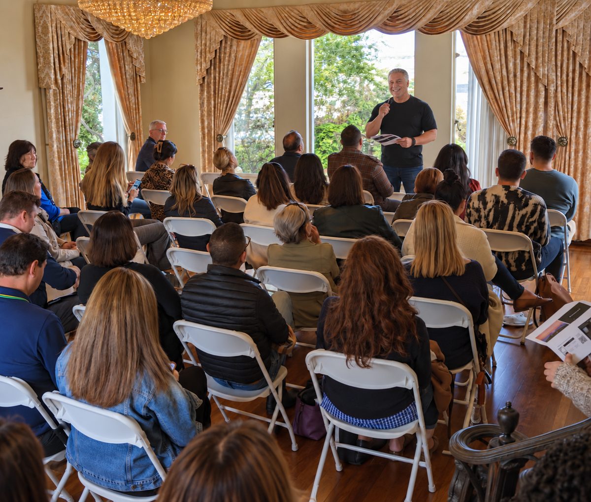 Sean Purcell speaking to a seated group in a bright ballroom